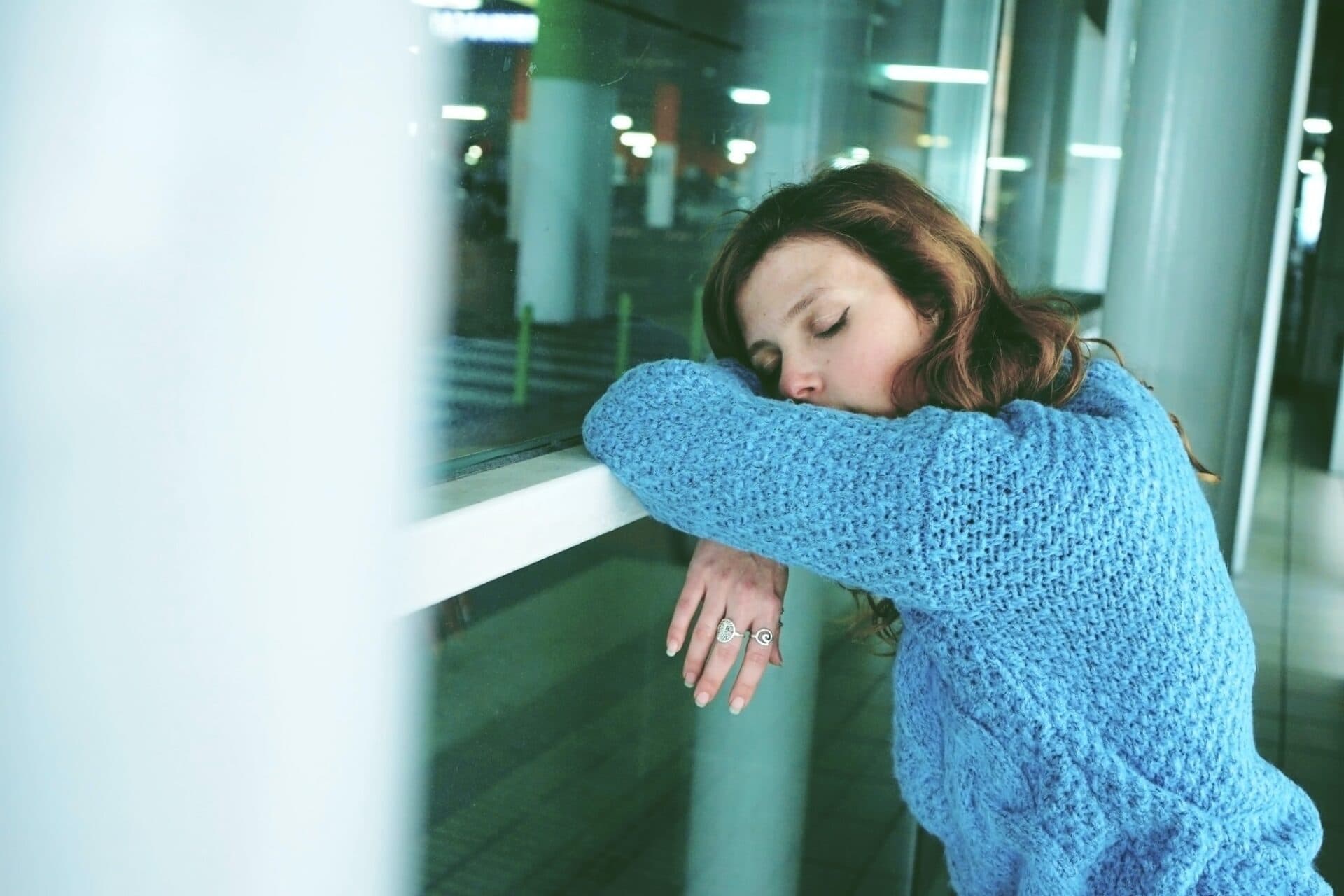 Young woman alone and tired in a bus station